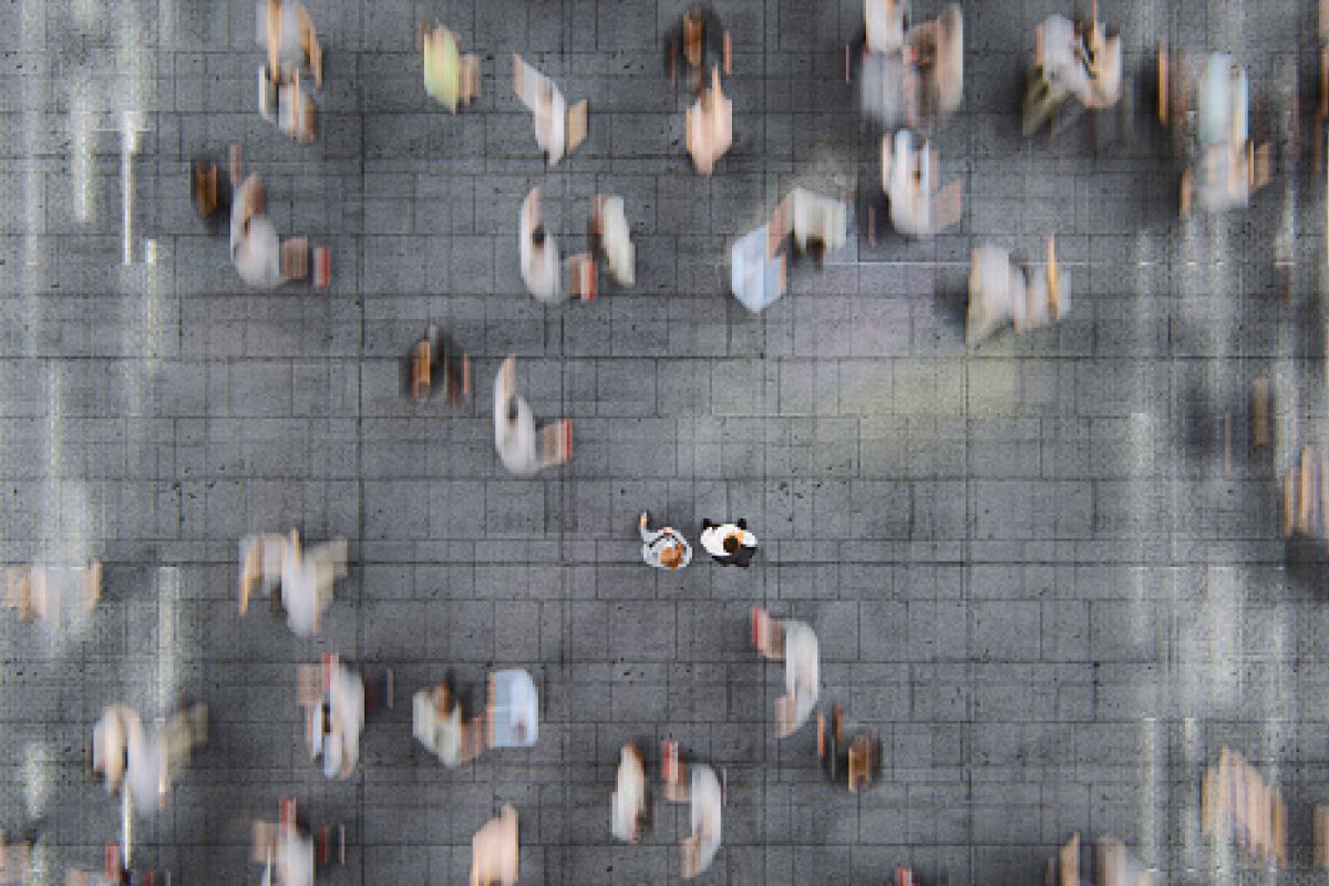 Businessman standing in the fast moving crowds of commuters