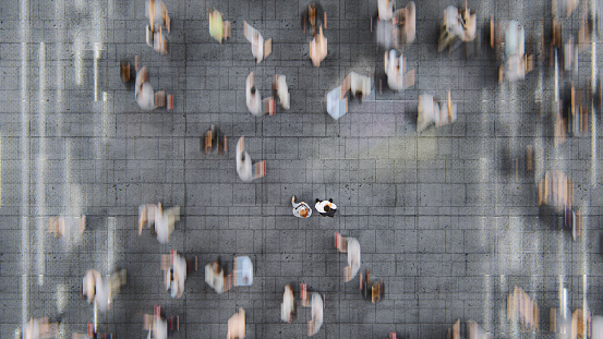 Businessman standing in the fast moving crowds of commuters