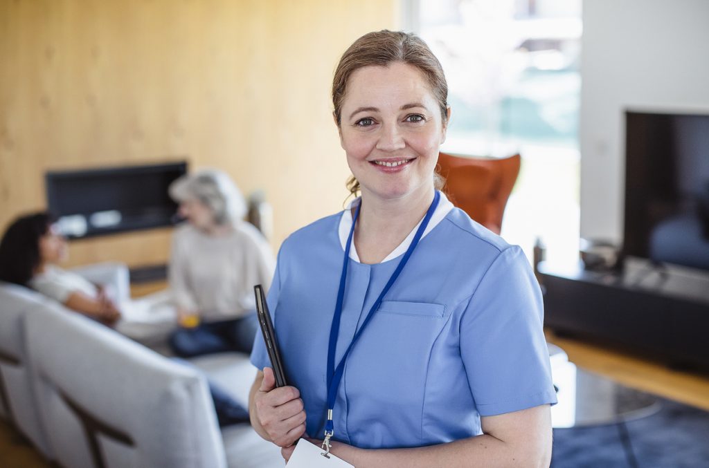 Nurse woman with senior patient woman at nursing home